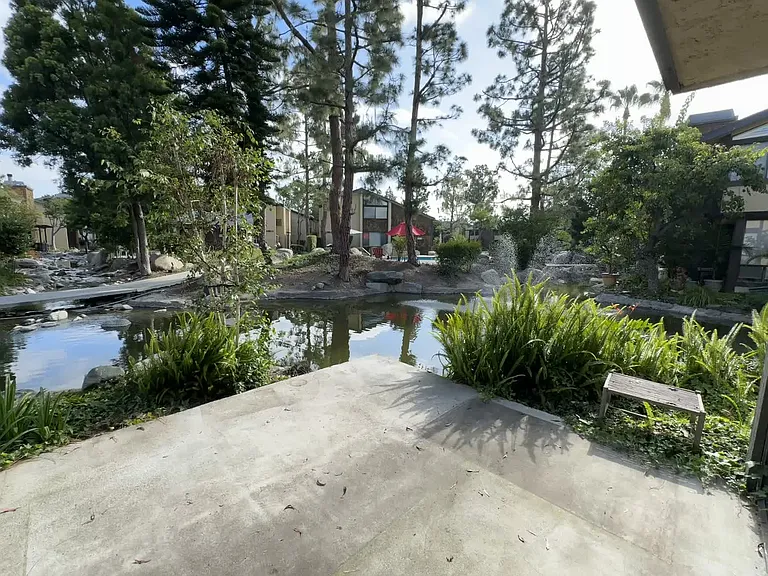 Patio off downstairs living room, open concept with a direct view the lake and outdoors like living. Serene water fountains and pool adjacent. Washer and Dryer hookups are also outside in a closed /locked cabinet