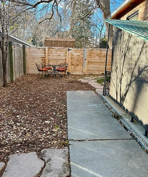 Back yard, southern exposure, sunny even in the winter, large trees provide shade in the summer, patio set included with unit.