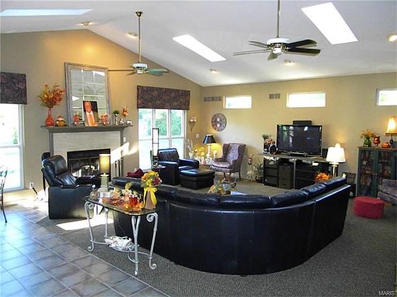 Spacious Great Room with vaulted ceiling and wood burning fireplace