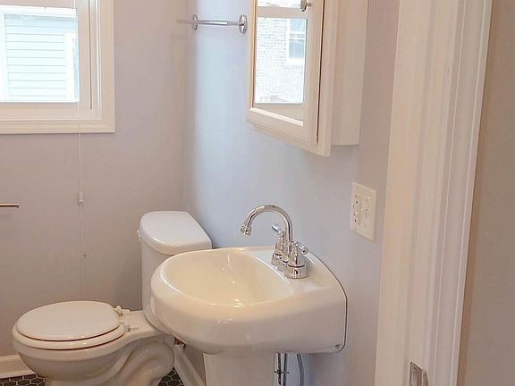View of the bathroom mirror and pedestal sink.