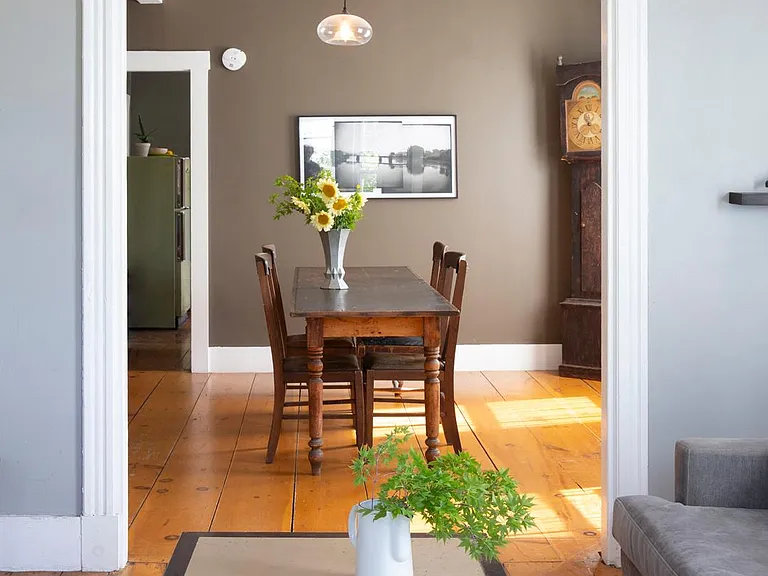 View from bay window in living room toward dining room. Kitchen in background.