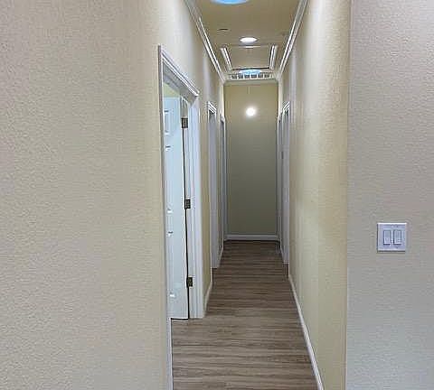 Hallway leading from from kitchen/dining area to the bedrooms and bathrooms