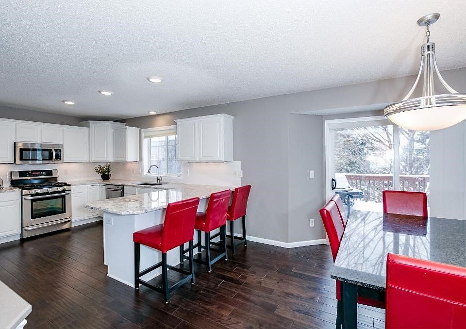 Open concept main floor features newly renovated kitchen and bayed dining area with hand-scraped birch flooring.