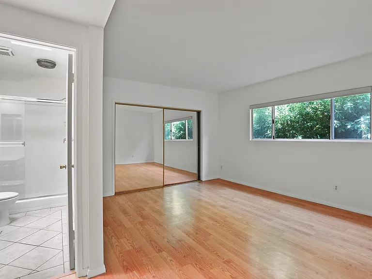 Bedroom with Bathroom, Closet, and Windows