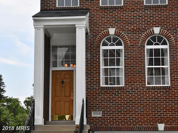 ALL brick front w/covered porch, curved windows