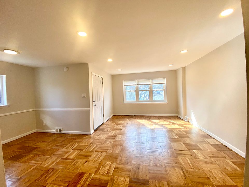 Spacious and bright living area with hardwood floors