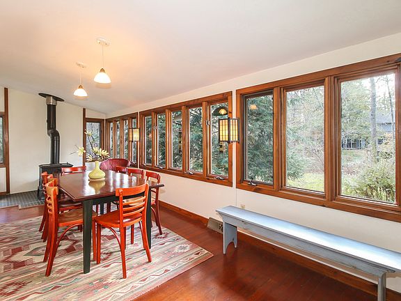 DR has wall of windows, hardwood floors & stove
