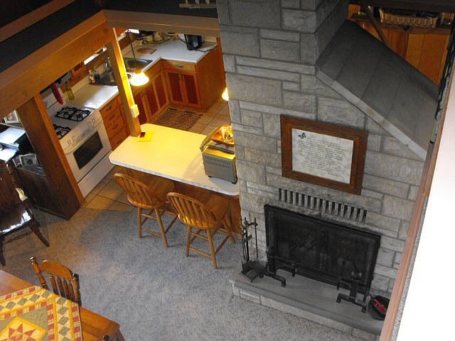 view of fireplace  from loft