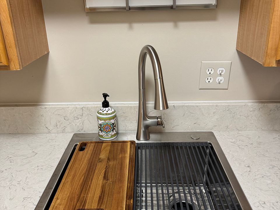 new stainless steel Kohler sink with built in ledge for accessories - cutting board and drying grate. New garbage disposal and under-sink water filter system as well.