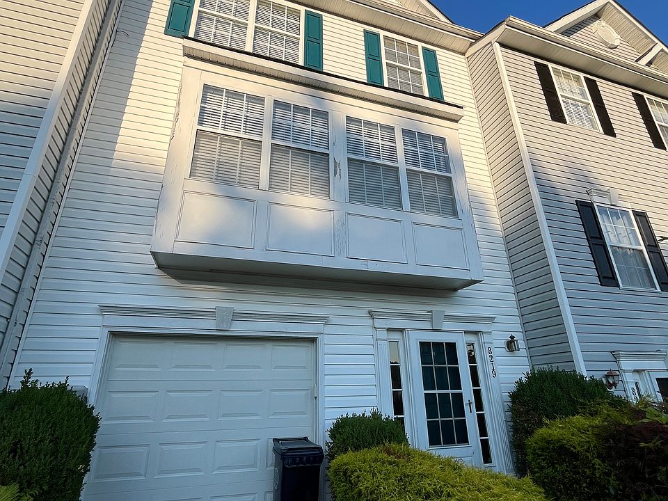 Landscaped front yard, garage, private drive overlooking private wooded view with no neighbors across the street