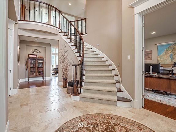 An elegant spiral staircase welcomes you! Office to the right, dining room on the left.
