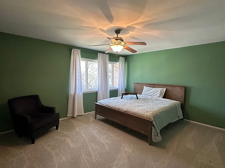 Spacious master bedroom with beautiful lighting overlook front of townhouse.