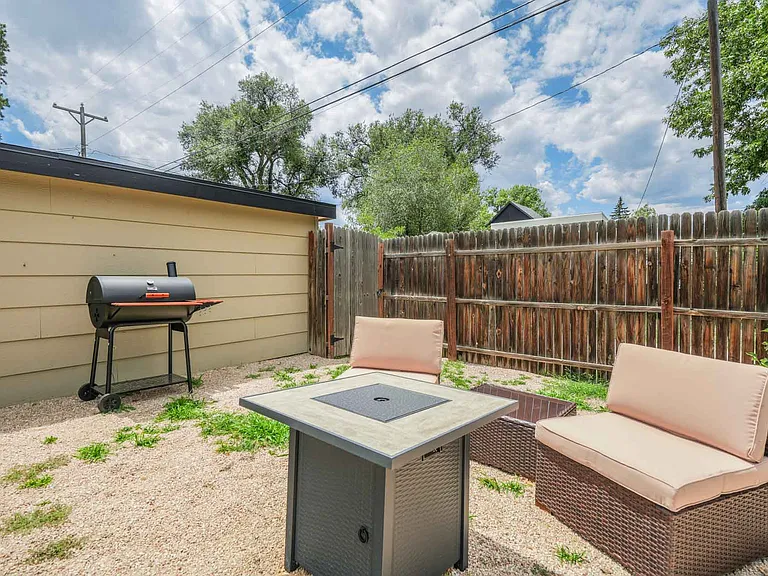 Fenced in Backyard with fire pit and grill!