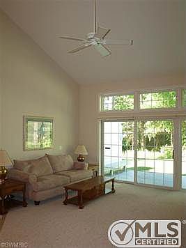 18' x 16' living room with vaulted ceiling and sliders to rear deck and yard