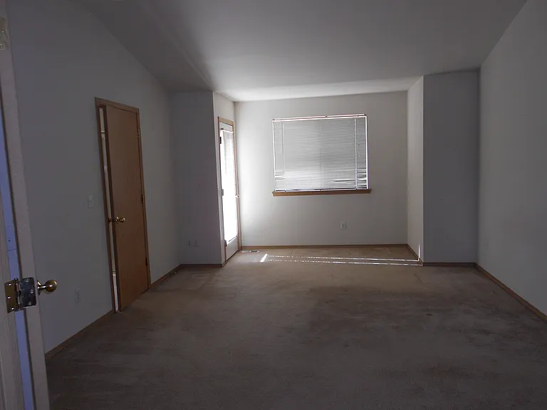 View into master bedroom, with door to bathroom and outside patio.