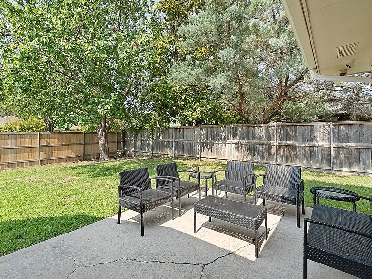 Fenced backyard with a patio area