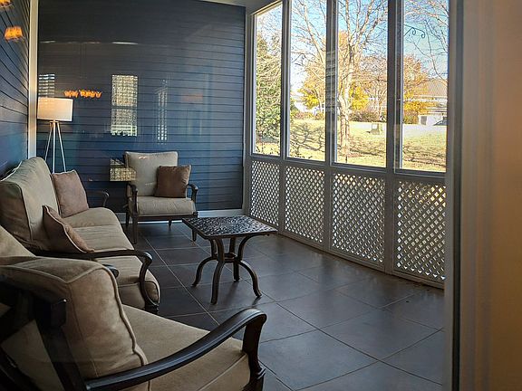 Screen porch faces golf path