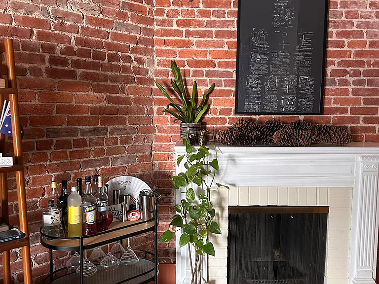 Exposed brick and beautiful mantle with original fireplace.