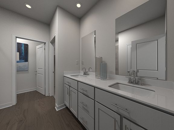 The primary bathroom offers dual vanity sinks and a walk-in shower.