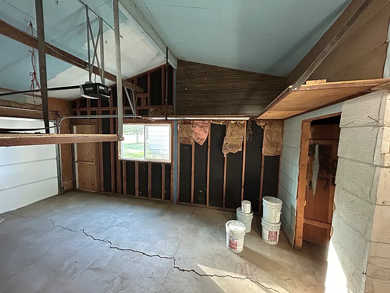 Garage space with storage closet.