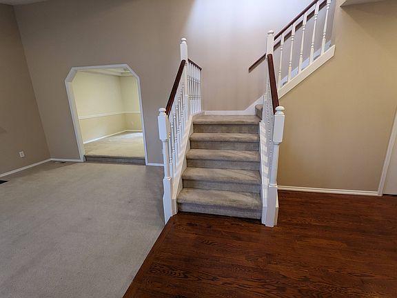 Enter to view a large living room and cherry hardwood floors