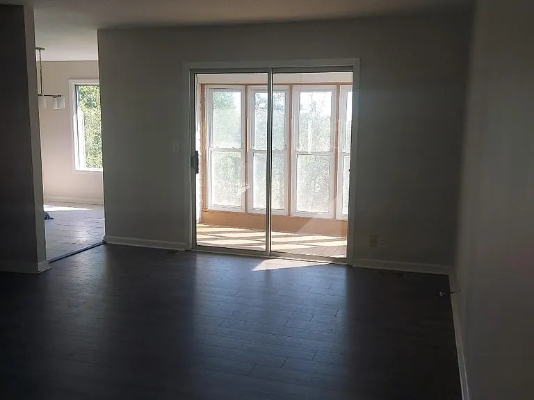 Living room looking into the sunroom.