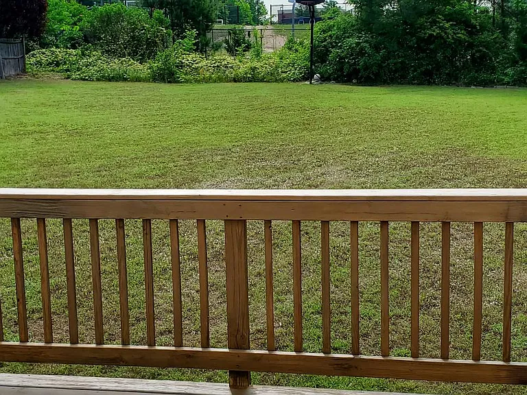 REAR DECK WITH LARGE FENCE YARD