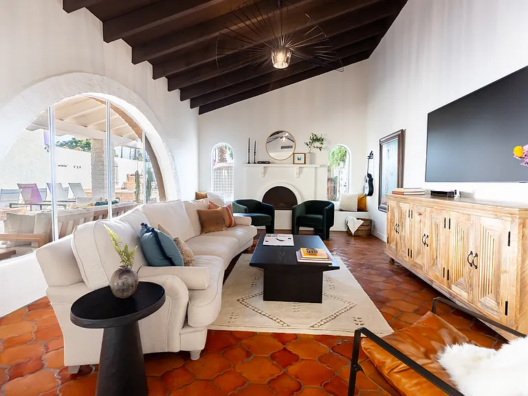 Main house living room, has gas fireplace and vaulted ceilings