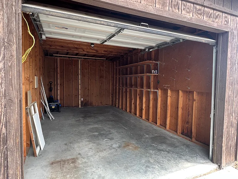 1 car garage with shelving, ski racks and bike hooks