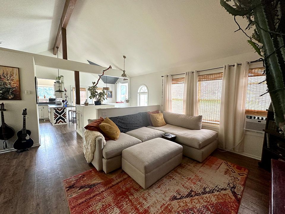 Upstairs living area that leads into kitchen and dining area.