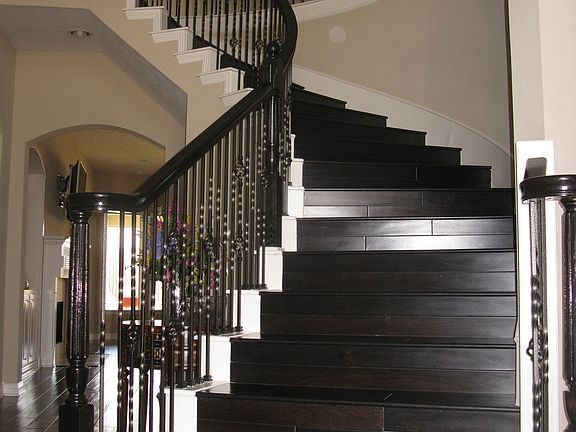 Spiraling Walnut Staircase with wrought iron spindles