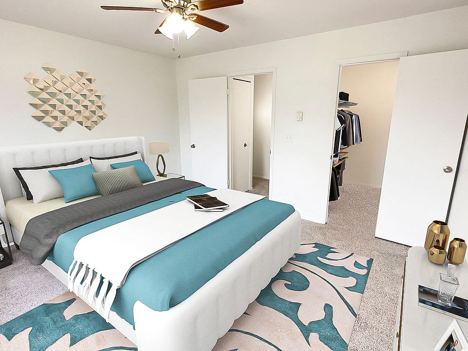 Bedroom with large walk-in closet, plush carpeting, ceiling fan, upgraded bath.