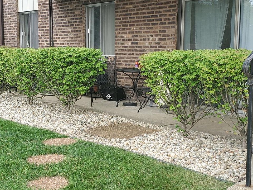 Patio has been updated with new shrubbery, stone and walking path