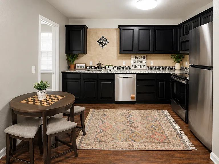 Shared Kitchen _ A spacious, fully equipped kitchen featuring stainless steel appliances, abundant cabinet and counter space, and a cozy breakfast table. Perfect for cooking, dining, and gathering with housemates.