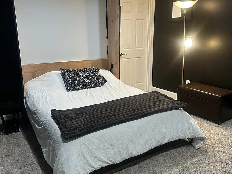 Basement bedroom with large closet and murphy bed. Egress window and also exits out to back yard/driveway/alley. Note the downstairs bathroom/bedroom is not for individual sublet, AirBnB, or other type of subcontract.