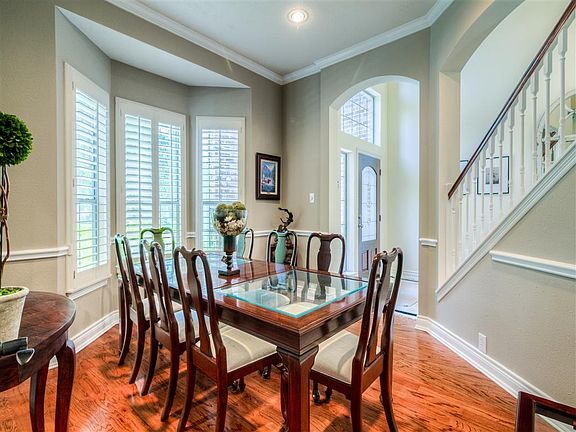 A formal dining room is just off the entry and features extensive molding and a bay window covered w