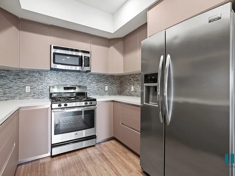 Kitchen with Stainless-Steel Refigerator, Dishwasher, Stove, and Microwave Oven