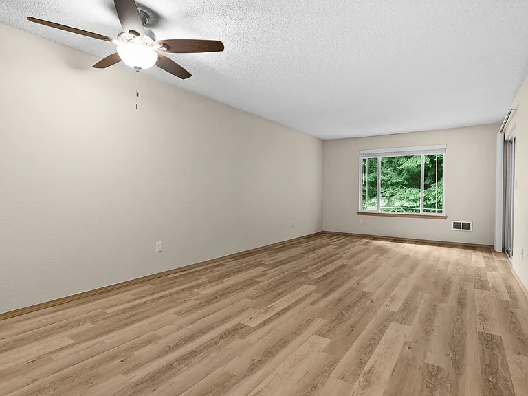 A bright, open living room with ample natural light and a peaceful view of the outdoors. A bright, open living room with ample natural light and a peaceful view of the outdoors.