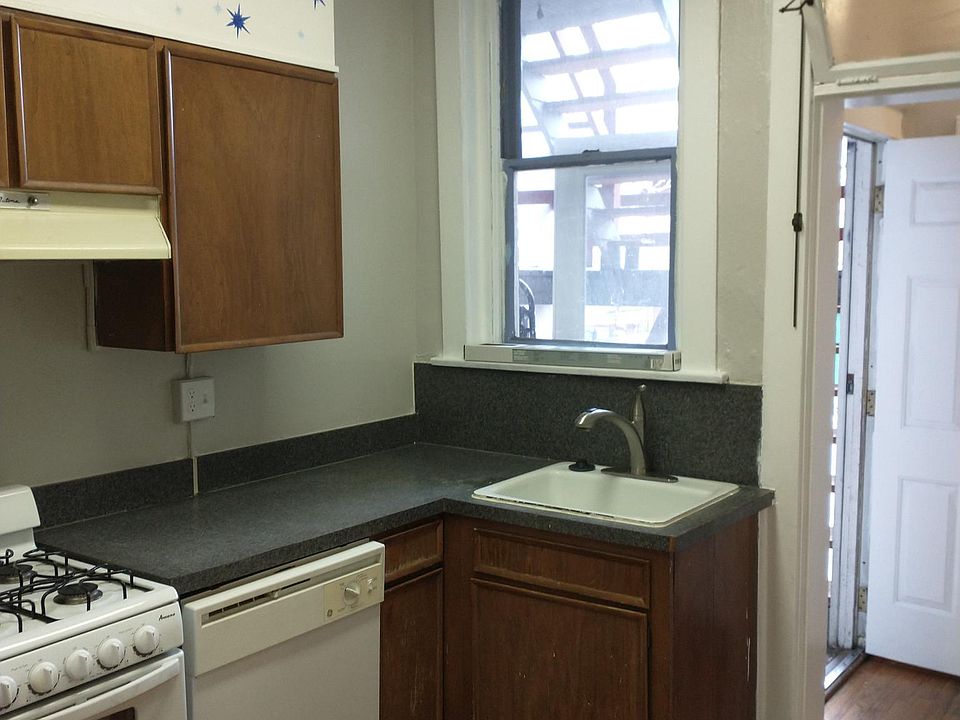 The kitchen from the other end. Dishwasher and sink.