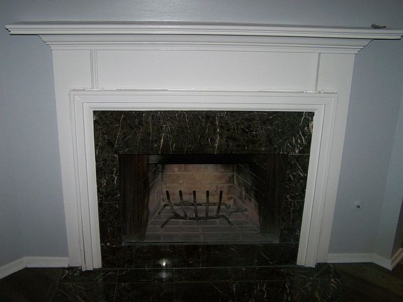 Gas burning fireplace with granite surround