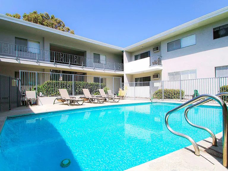 Beautiful gated pool with lounging area.