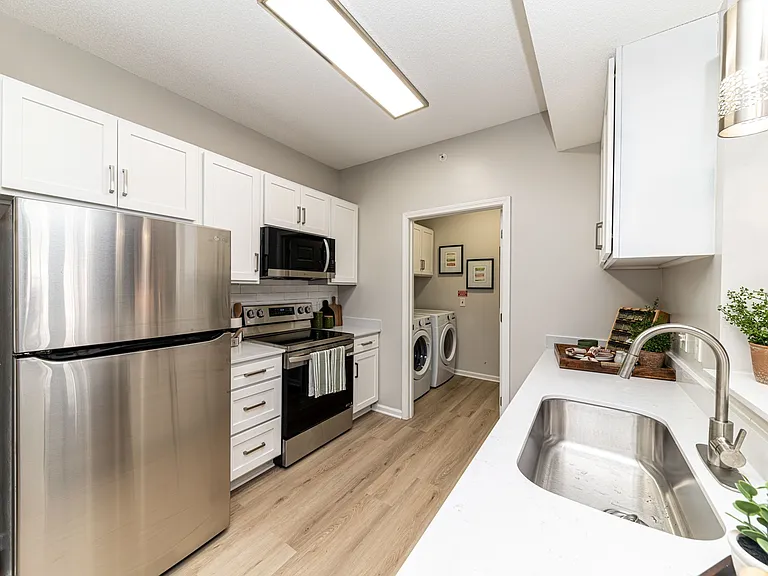 Kitchen with quartz counters, modern cabinetry, & stainless appliances