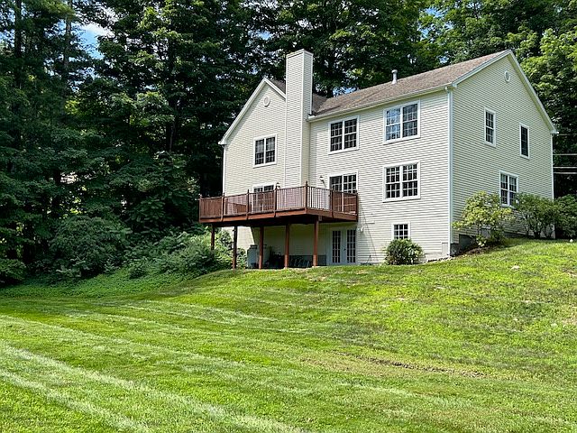 Back View & yard of 3 story home with finished walk-out basement.