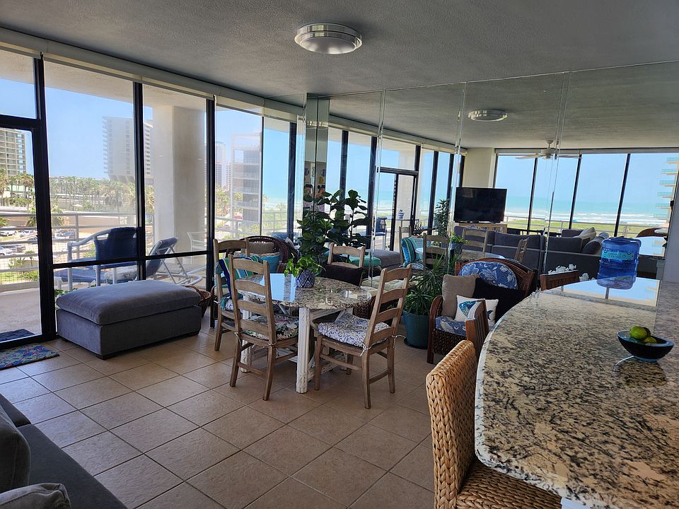 open concept living and dining room overlooking gulf views and pool