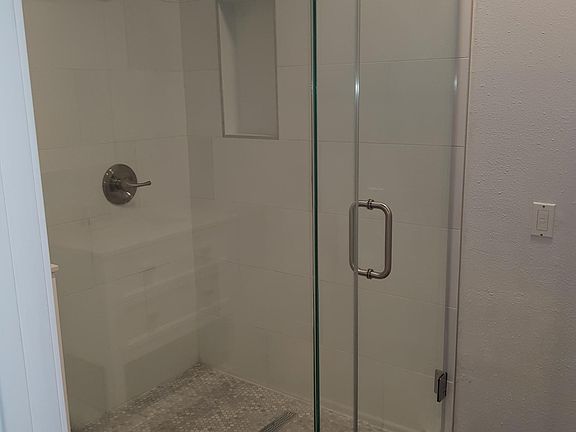Frameless glass enclosed shower