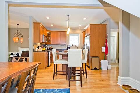 Open kitchen off of dining area - cabinets have been painted since this photo
