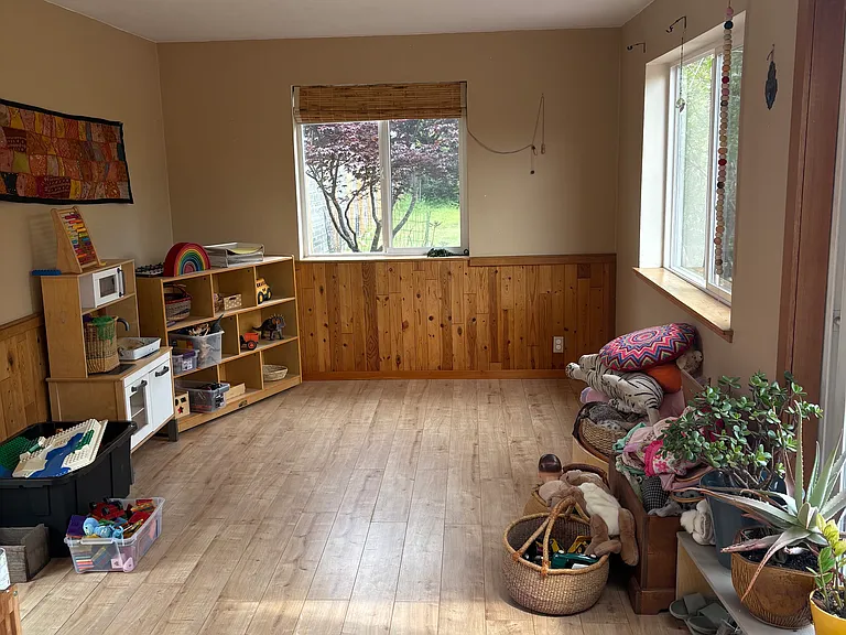 This is the room that was added on to the home. For years it was a bedroom. The current tenant runs a daycare, and it has been used as the main room for the daycare. Current tenant is packing up to move. This room has two slider doors, and the windows.