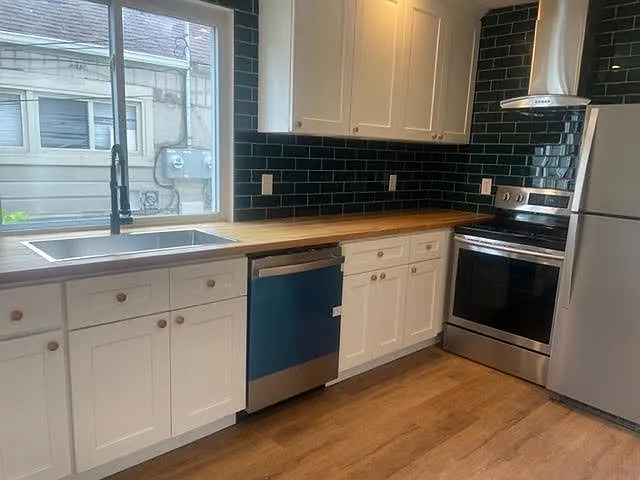 New cabinets, stainless steel appliances, new subway tile, dishwasher, new range hood.