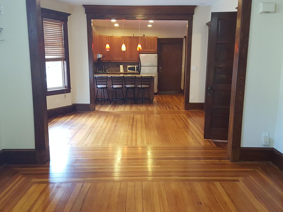 standing in living room, looking into dining room and kitchen