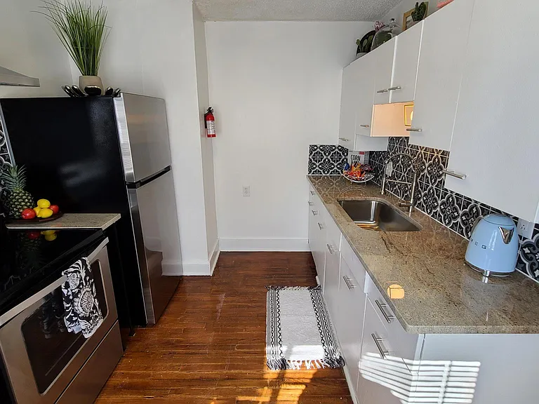 Kitchen with new Granite Countertops with Original Metal Cabinets, Stainless Steel Appliances, and Custom Tile Backsplash